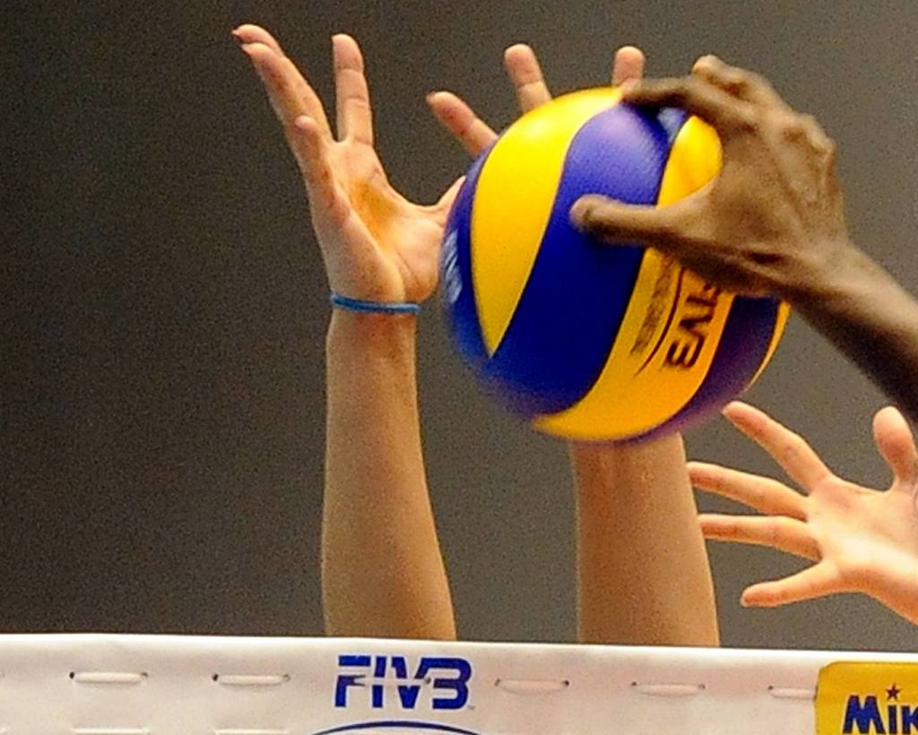 A volleyball and some hands